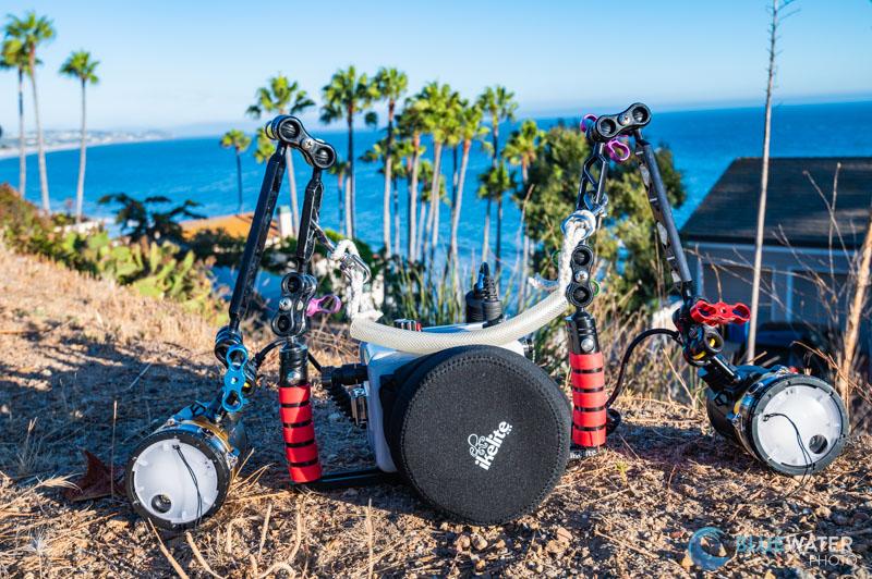 A fully decked-out Canon R100 system in the field - with two YS-D3 duo strobes, an Ikelite R100 housing, and ultralight arms and colored clamps. A fully decked-out Canon R100 system in the field - with two YS-D3 duo strobes, an Ikelite R100 housing, and ultralight arms and colored clamps.